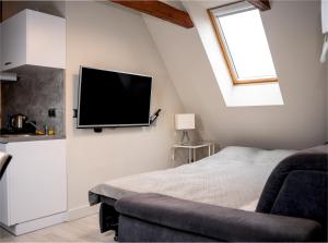 a bedroom with a flat screen tv on the wall at Apartamenty Pyskowice in Pyskowice