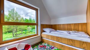 a small bedroom with a window and a bed at Willa Izerska z ogrodem by Royal Aparts in Pobiedna