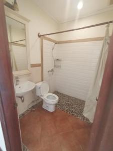 a bathroom with a toilet and a sink at Phasouk Viengmai Villa in Luang Prabang