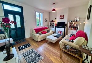 a living room with two couches and a door at Le “Chez-nous” - Maison atypique de 90m2 in Dieppe