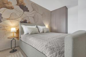 a bedroom with a bed with a painting on the wall at Luxury Apartment Nugal- heated pool in Makarska +25 photos