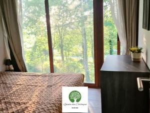a bedroom with a bed and a window with a sign on it at Quinta das Carbonças in Fafe +28 photos