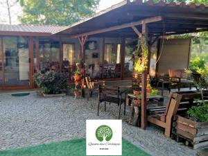 a restaurant with a patio with tables and chairs at Quinta das Carbonças in Fafe