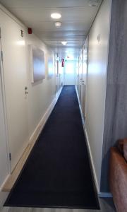 a hallway in an office building with a long carpet at Kuukkeli Saariselkä Inn in Saariselka