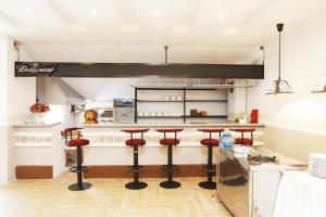 a kitchen with a counter with bar stools at Empress Dalat - Sky View Hotel in Da Lat