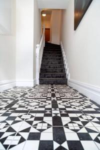 a hallway with a black and white checkered floor at Unit 3 Modern Self Contained Apartment in Cobh