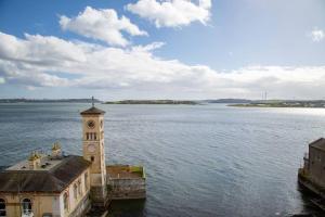 a clock tower in the middle of a body of water at Unit 3 Modern Self Contained Apartment in Cobh