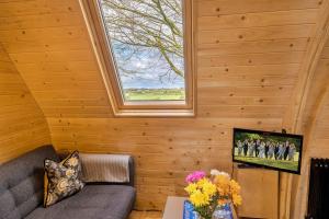 a living room with a couch and a window at Finest Retreats - The Pods in Camerton