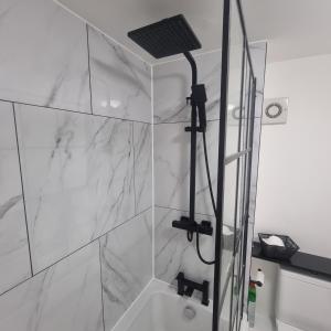 a bathroom with a shower with a glass wall at Quite central flat in Plymouth