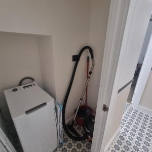 a refrigerator in a room with a vacuum at Quite central flat in Plymouth