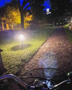 a bike parked in a park at night at Villa Sarchi in Grantola