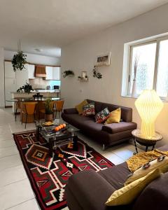 a living room with a couch and a table at Top location Sliema stylish rooms in Sliema