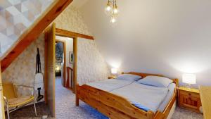 a bedroom with a wooden bed and a staircase at Ferienhaus Fischerhaus in Seedorf
