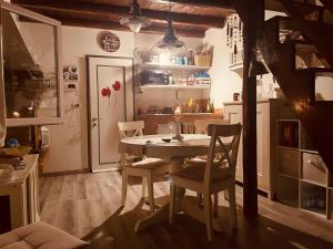 a kitchen with a table and chairs in a room at La dolce dimora in Chioggia