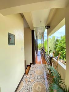 a hallway of a house with a rug on the floor at SHELVES SIARGAO in General Luna