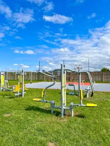 a row of playground equipment in a park at Resto domki letniskowe in Sarbinowo