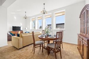 a dining room and living room with a table and chairs at Apartament Bursztynowy in Gdańsk