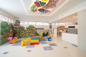 a childs room with a play area with toys at Residence Continental Resort in Gabicce Mare