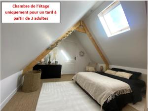una camera mansardata con letto e finestra di YVECRIQUE - Maison avec Jardin tout confort 2 à 6 pers 
