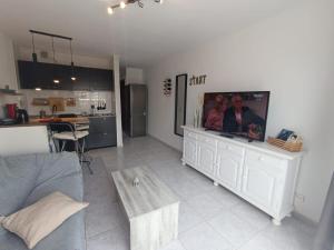 a living room with a flat screen tv on a entertainment center at Apartmento START Complex Amaya Fuerteventura in Costa de Antigua