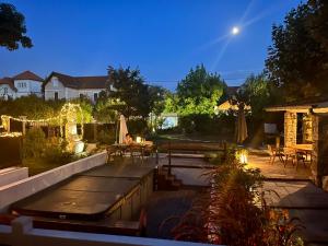a backyard with a pool and a table and chairs at Villa AJNA Bayonne in Bayonne
