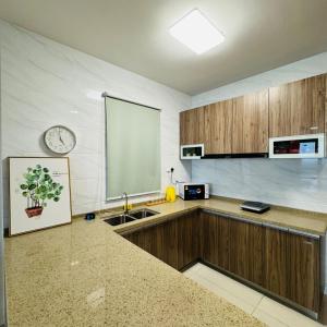 a kitchen with a chalkboard on the wall and a clock at Seaview 2B1R 5pax Condo Forest City 1G-1608 in Gelang Patah