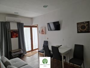 a living room with a couch and a table and chairs at Quinta das Carbonças in Fafe