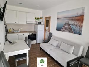 a kitchen and a living room with a couch and a table at Quinta das Carbonças in Fafe