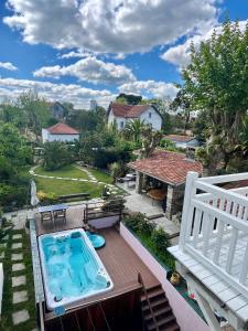 a balcony with a swimming pool and a house at Villa AJNA Bayonne in Bayonne