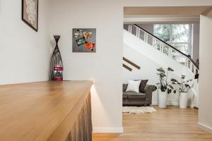 a living room with white walls and a staircase at Willa Klonowa in Wisła