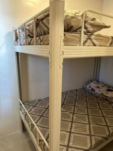 a couple of bunk beds in a room at Windmill Chimes in Rizal