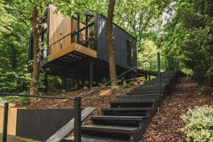 a modern house in the woods with wooden stairs at LagomHome Luxus Pihenőház ***** Noszvaj in Noszvaj