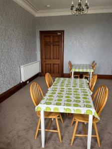 uma sala de jantar com uma mesa e quatro cadeiras em Conval House Bed And Breakfast em Dufftown