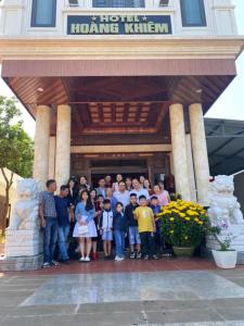 a group of people standing in front of a building at Hoàng Khiêm Hotel in Pleiku