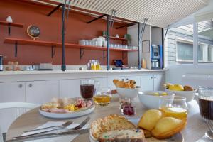 a table with breakfast foods on it in a kitchen at ibis Styles Aubagne Gemenos in Gémenos