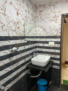 a bathroom with a toilet and a sink at Dayal International - New Digha in Digha