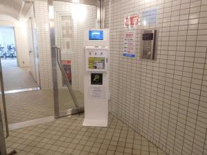 a machine in a bathroom with a tiled wall at シティラデファンス - 市営東西線 琴似駅徒歩2分 - リニューアル済の少人数旅行に最適な快適ステイ in Sapporo