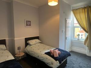 a bedroom with two beds and a window at Apartment 3 Petteril House in Carlisle