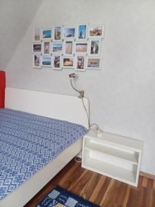 a bedroom with a bed and pictures on the wall at B&B Koeln Zuendorf in Cologne