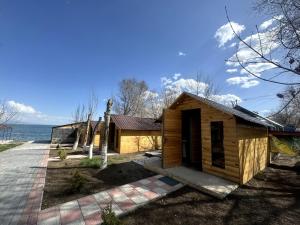 a small wooden cabin next to the water at Anabella Sevan - Коттеджи рядом с озером Севан (Sevanavanq) in Sevan