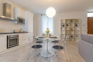 a kitchen and dining room with a table and chairs at At Home-Como Lake in Como