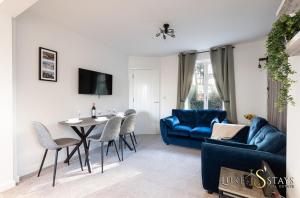 a living room with a blue couch and a table at Luke Stays - Finchale Ave in Sheepscar