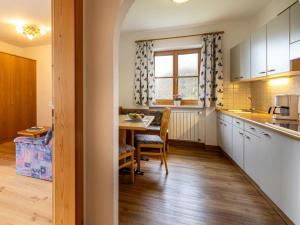 a kitchen with a table and a dining room at Rastenfeldhof in Parcines