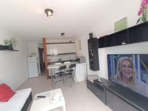 a living room with a large flat screen tv at Apartamento SUMMER Complex Amaya Fuerteventura in Costa de Antigua