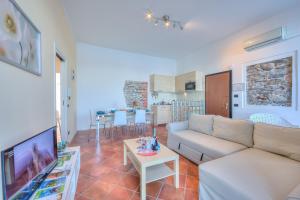 a living room with a couch and a table at Aparthotel Arona - Happy Rentals in Arona