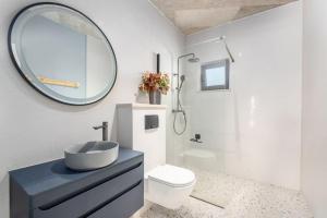 a bathroom with a sink and a toilet and a mirror at Villa Andy Rovinj in Rovinj
