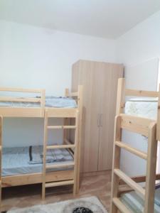 a room with three bunk beds and a closet at Bujtina Bego in Çorovodë +21 photos