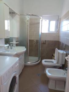 a bathroom with a sink and a toilet and a shower at Bujtina Bego in Çorovodë