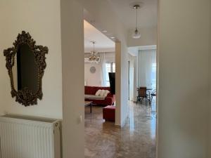 a hallway with a mirror and a living room at Family Apartment in Nea Moudania