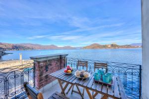 a table and chairs on a balcony with a view of the water at Aparthotel Arona - Happy Rentals in Arona